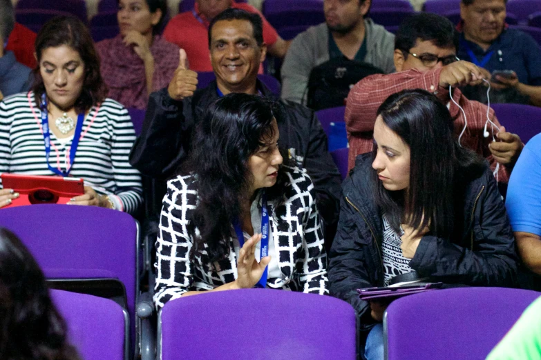 two women looking at one another and smiling