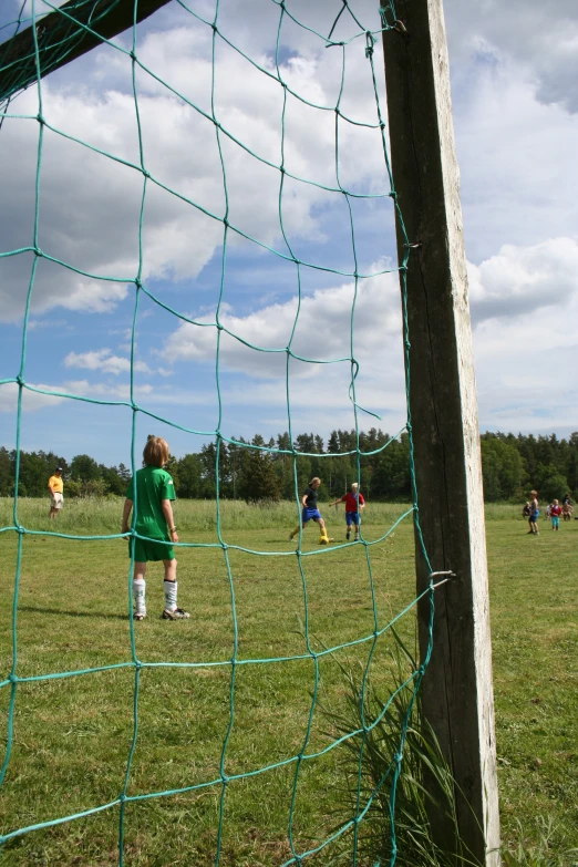 children playing soccer on a sunny day in a field