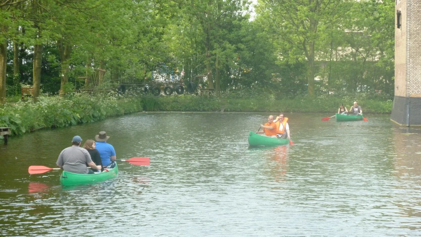 three people are rowing canoes through the water