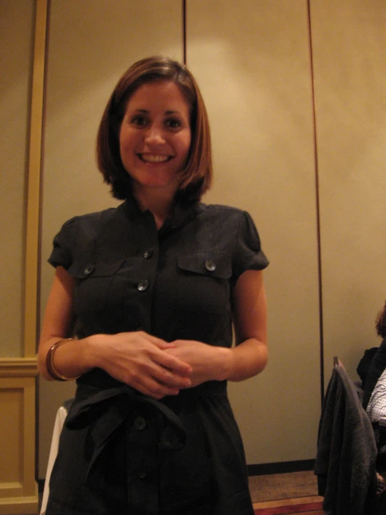 woman with arms crossed, smiling for the camera