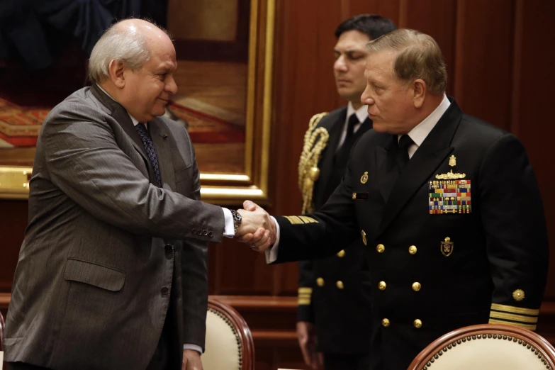 an image of two men in military uniform shaking hands