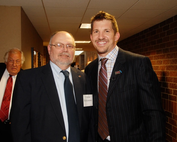 two men are smiling and standing near each other