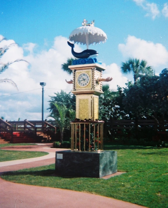 a statue with a cat on top with a clock