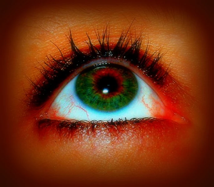 an eye with colorful eyelashes is seen here