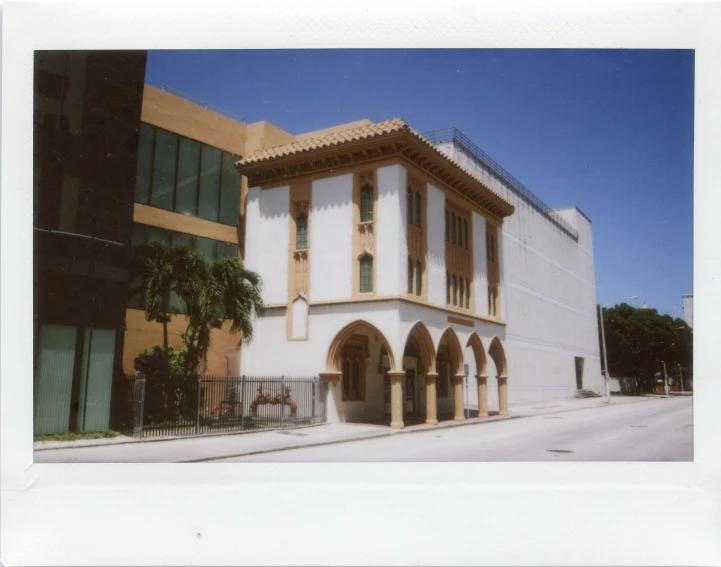 a building on a street corner with lots of arches