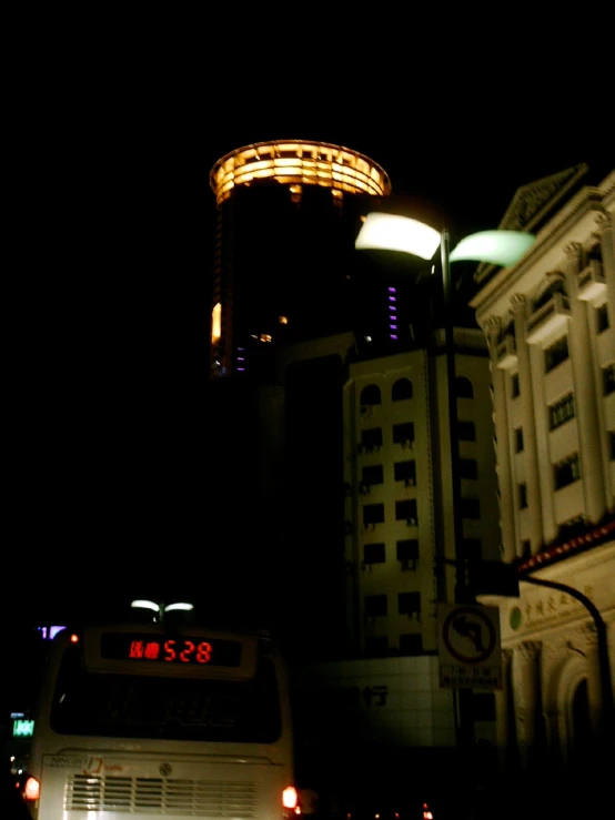 a white bus at night in front of a building