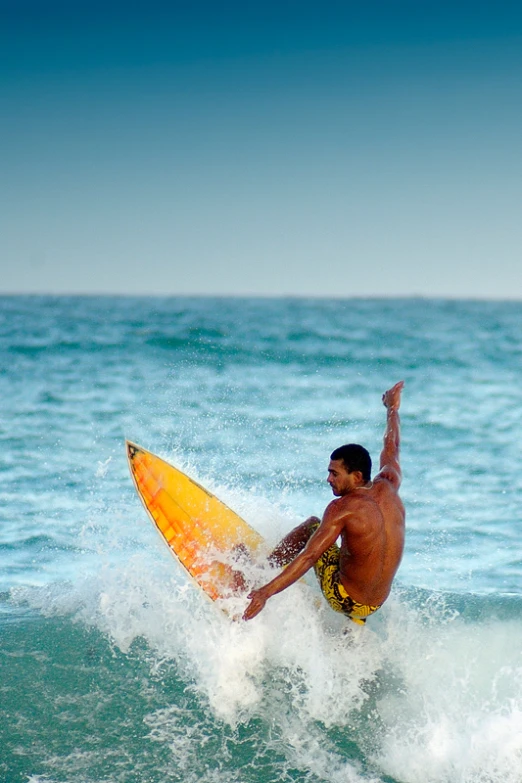 a man is surfing on top of an ocean wave