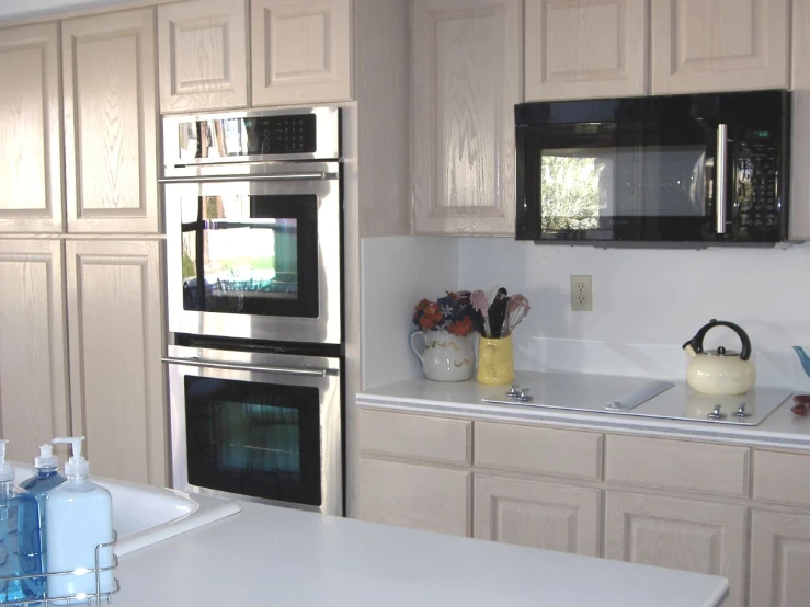 a kitchen with lots of counter space, including a stove and microwave