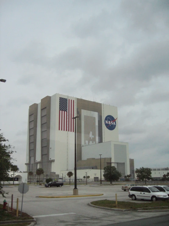 a very tall building with a big american flag on top of it