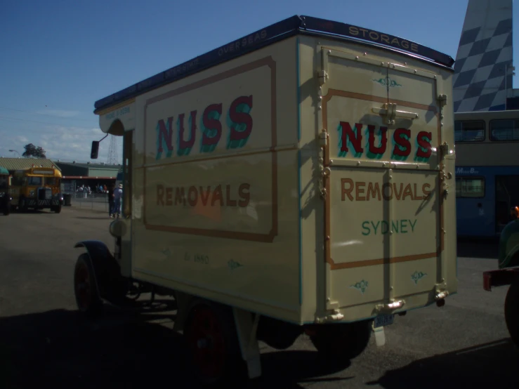 a box truck in a parking lot near another truck