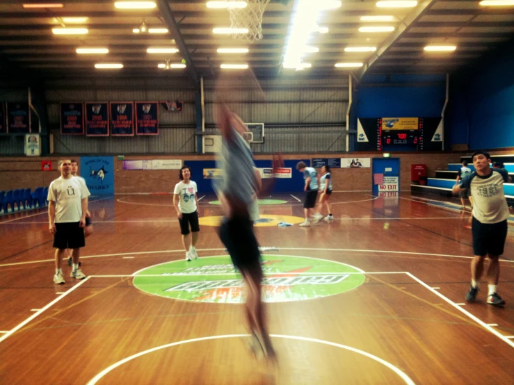 a large basketball court is surrounded by people