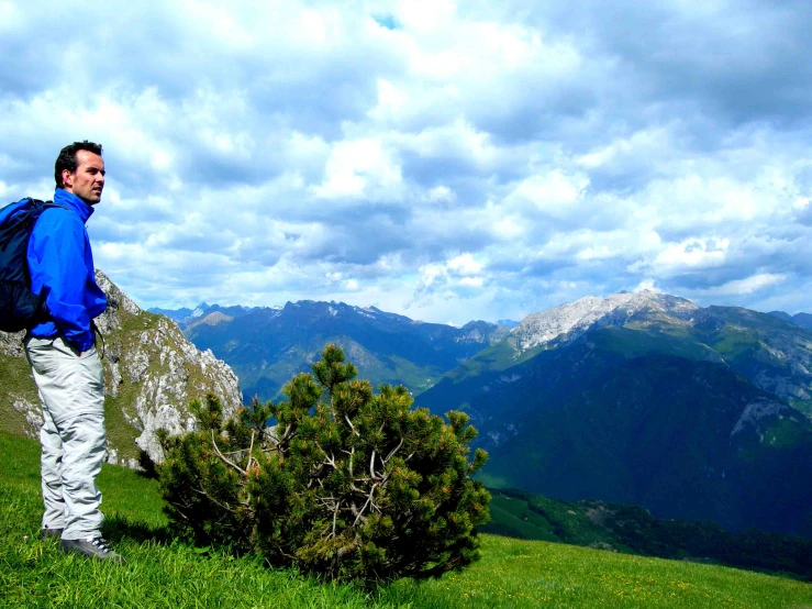 a person standing on a hill looking at the camera