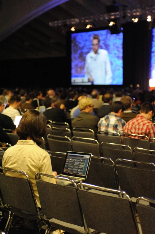 a large crowd watching a show in an auditorium