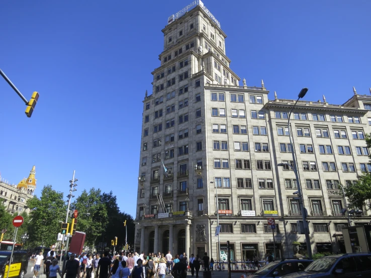 a tall building on the corner with a very tall tower