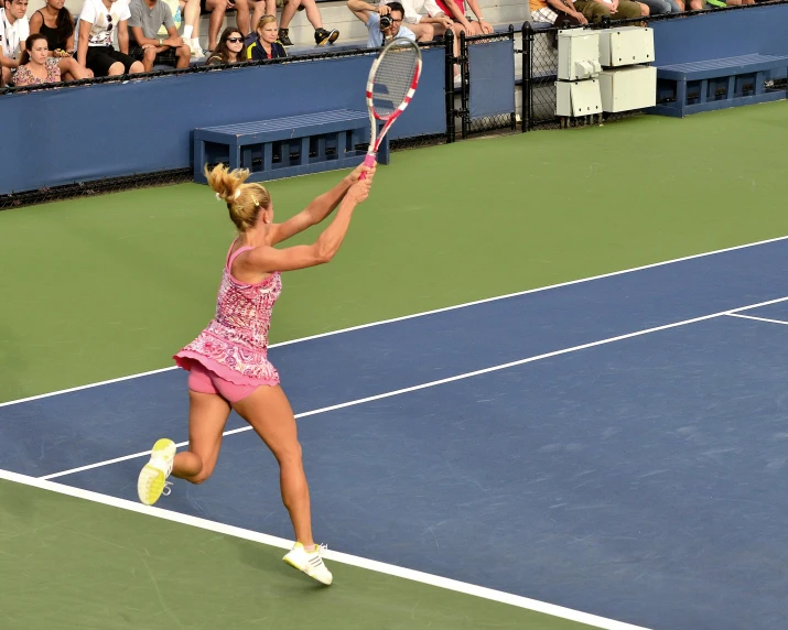 woman returning a ball on a tennis court