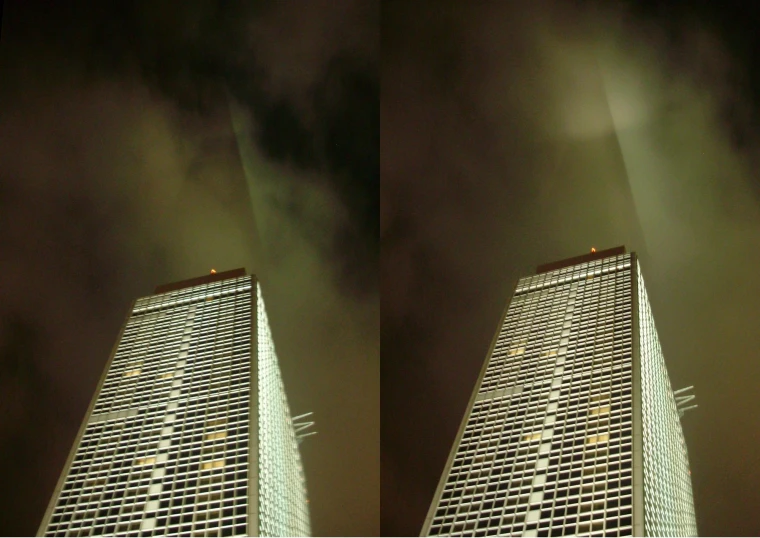 two buildings in the sky on an overcast night