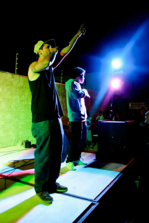 a man standing on top of a stage with a microphone in his hand