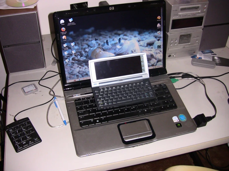 laptop computer sitting on table with other electronics