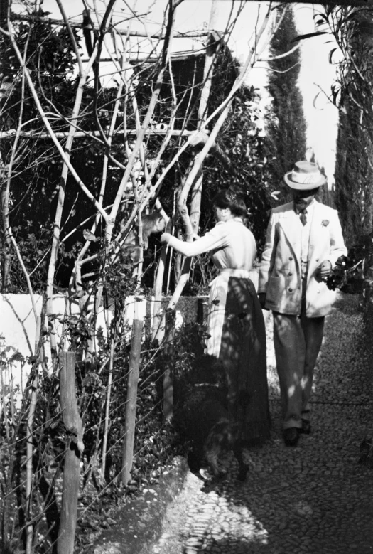 two people walking down the street next to each other