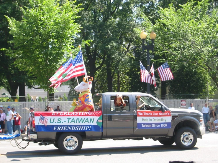 a truck with an american flag decoration and a statue in the back