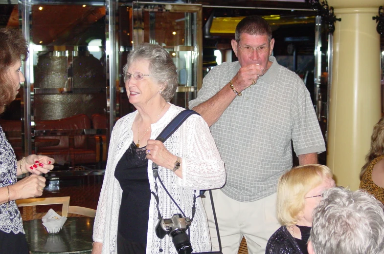 a group of people holding a camera and laughing