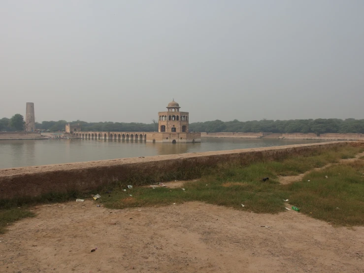 water surrounding an ancient building near some banks