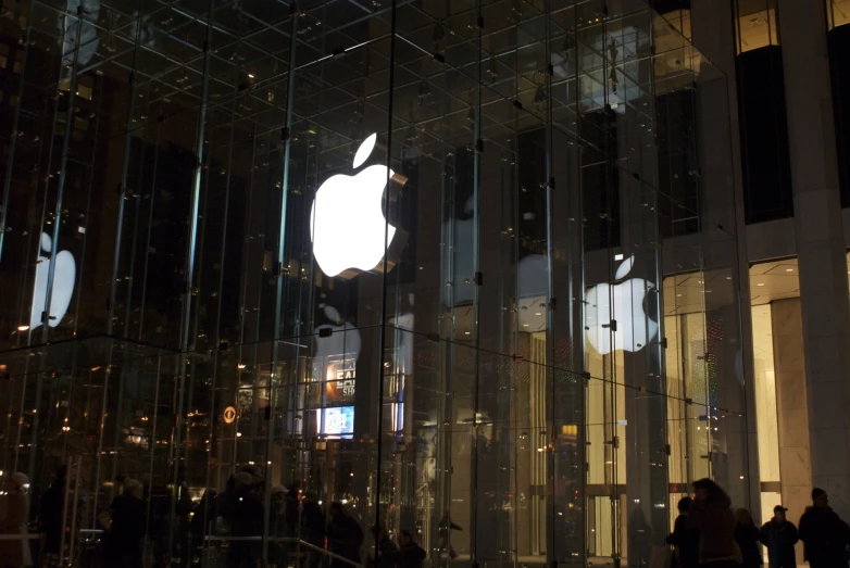 a bunch of people walking around in an apple store