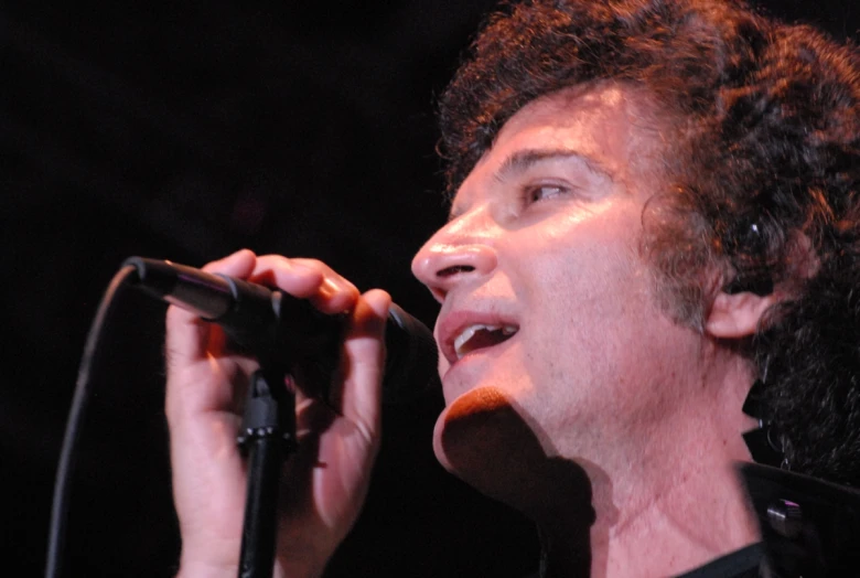 an image of a man singing into a microphone