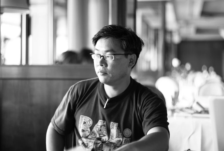 a man sits alone at a restaurant and stares