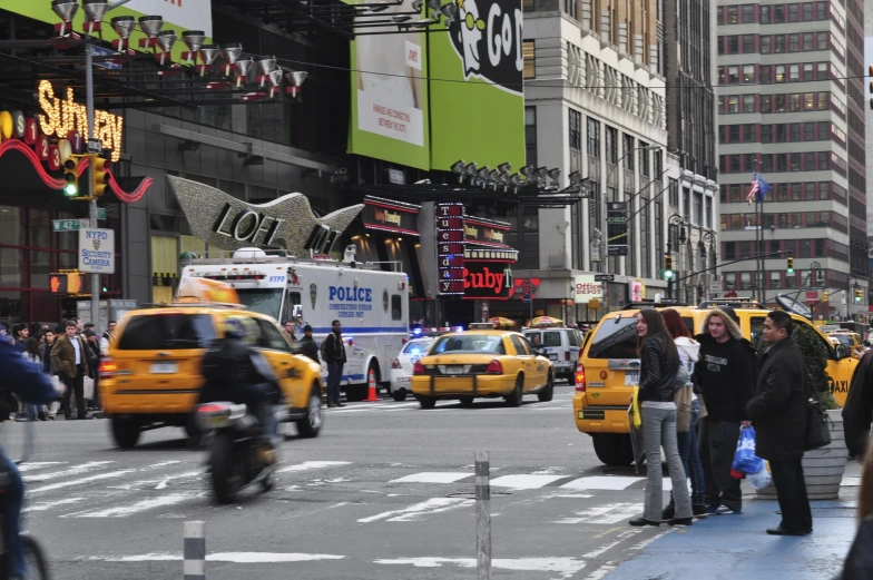 taxis and pedestrians in the metropolitan city with billboards