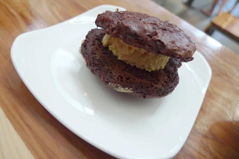 a couple of chocolate cookies sitting on top of a white plate