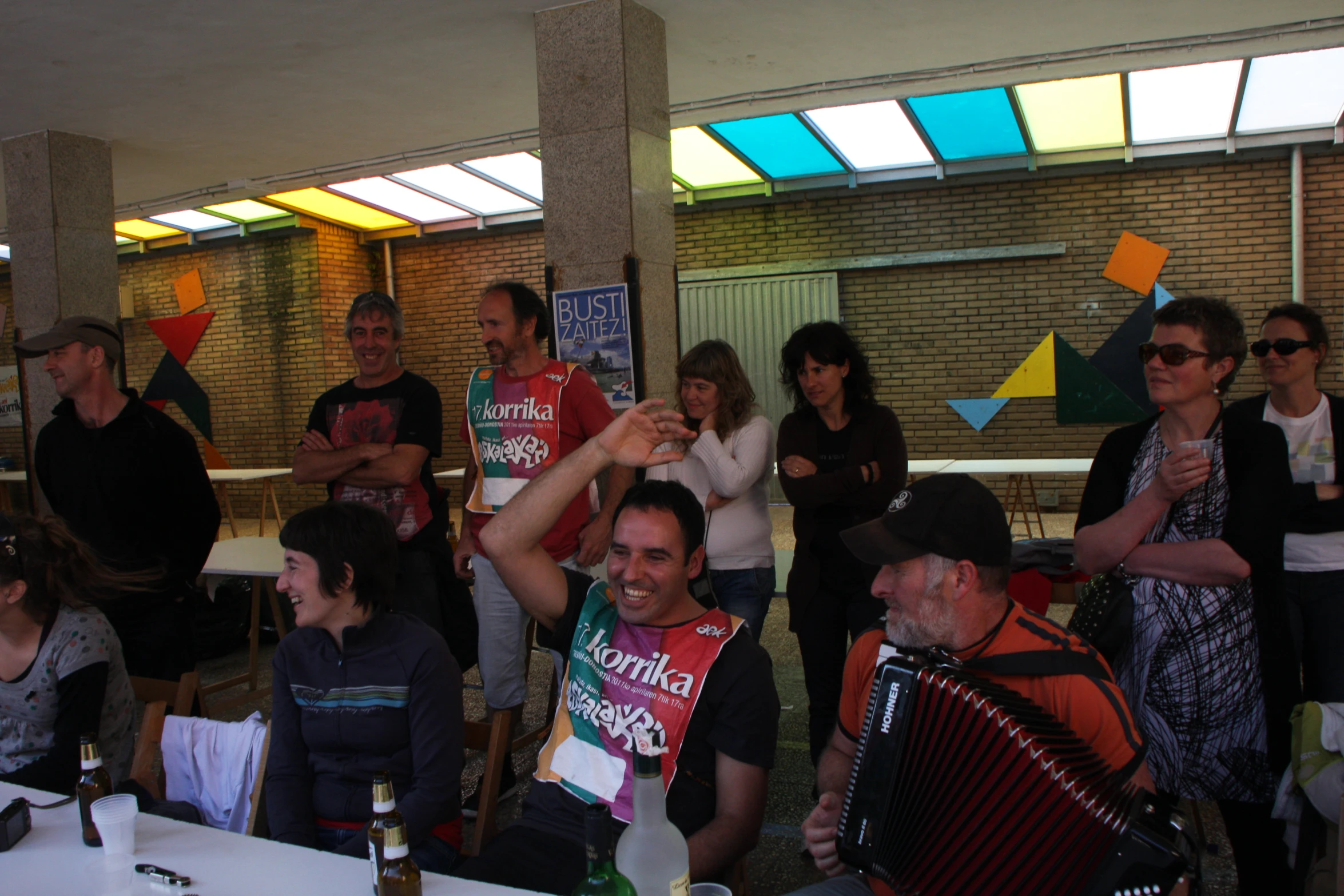 a crowd of people waiting to have drinks and accordions