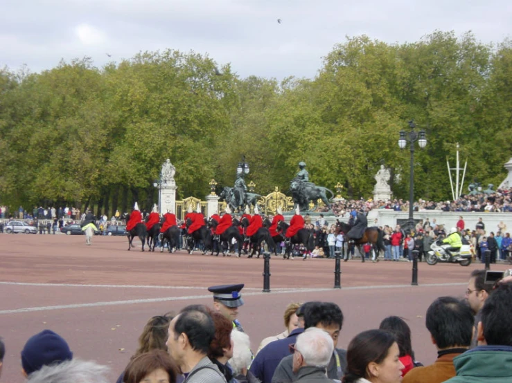 people on horseback, marching, and some on fire hoses in a parade