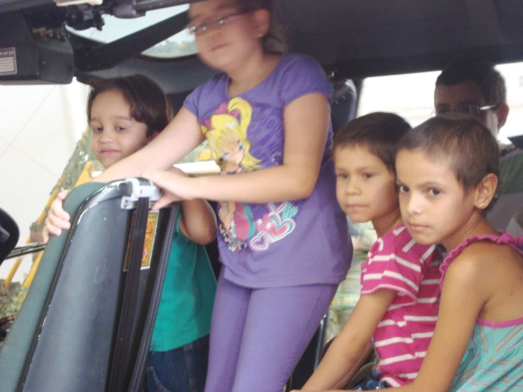 a family sitting in the back seat of a car