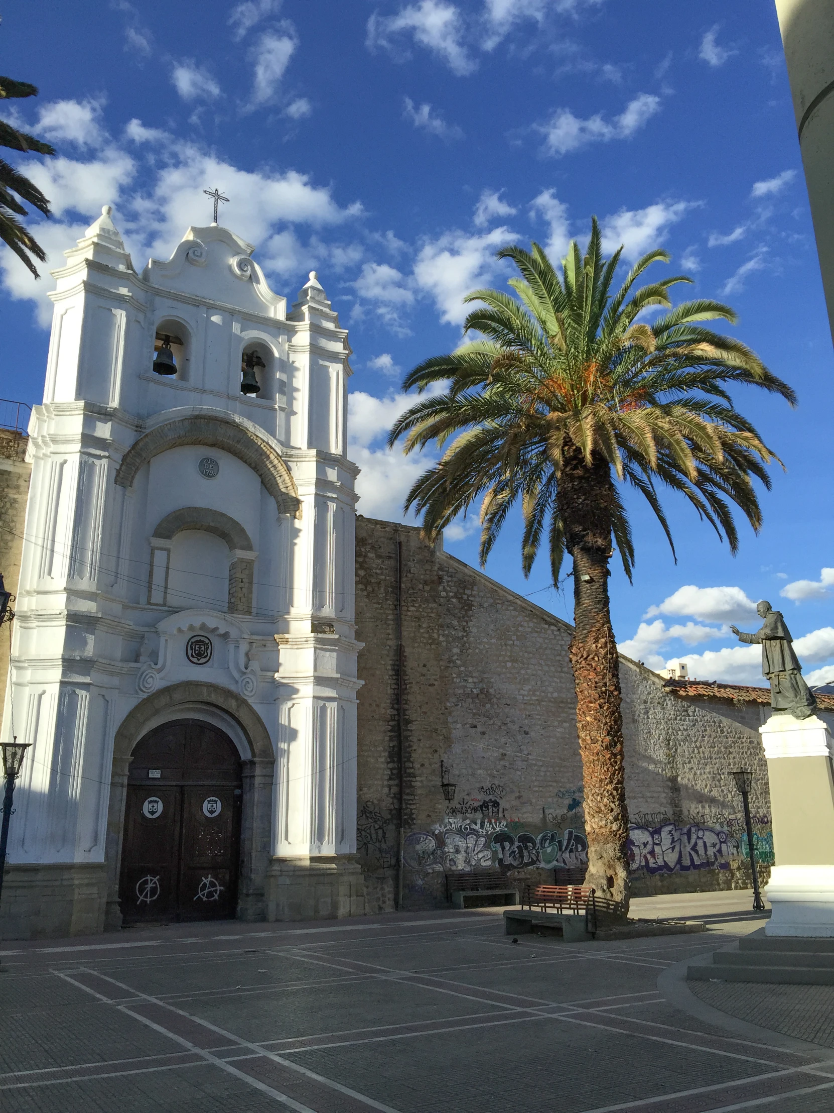 a building and two palm trees in front of it