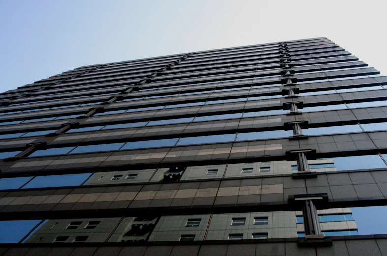 a large glass skyscr tower against a clear sky