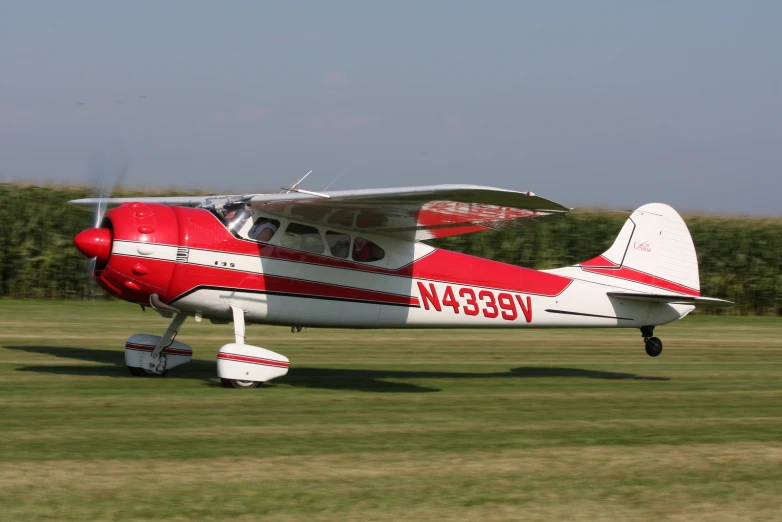 an aircraft sits on the ground in a field