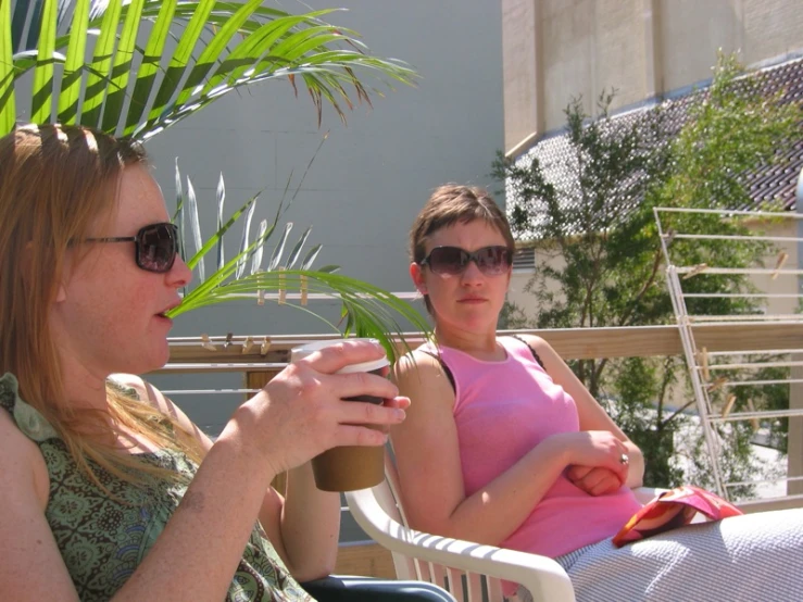 two women who are sitting in chairs eating