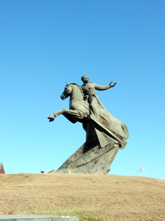 a statue that is standing on the grass