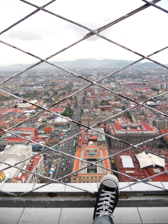 an airplane wing with a person looking out over a city