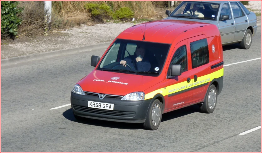 there is a red van driving down the street