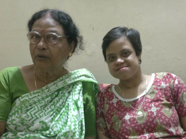 two ladies dressed in sari and eye glasses