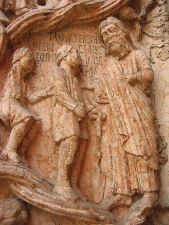 carved statues of various people holding hands and two looking to one another