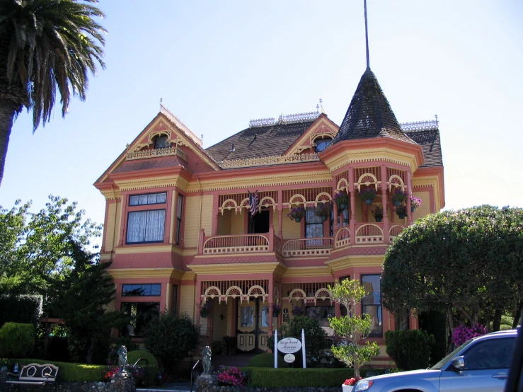 a very large house with elaborate architecture next to a street