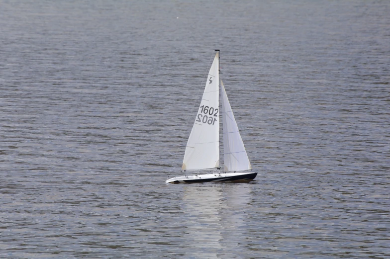 a sailboat is in the water with a large area
