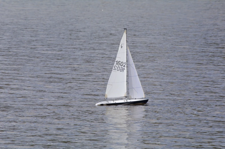 a sailboat is in the water with a large area