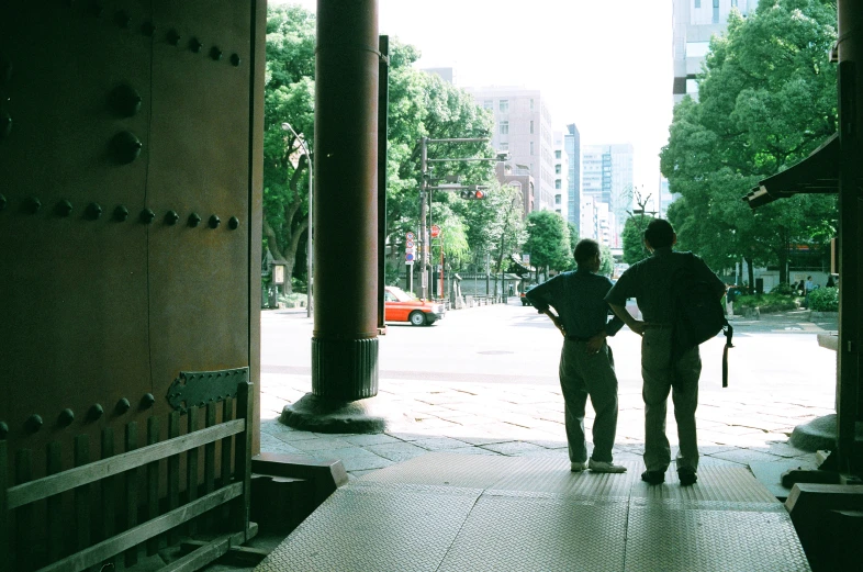 two people are walking up an open street