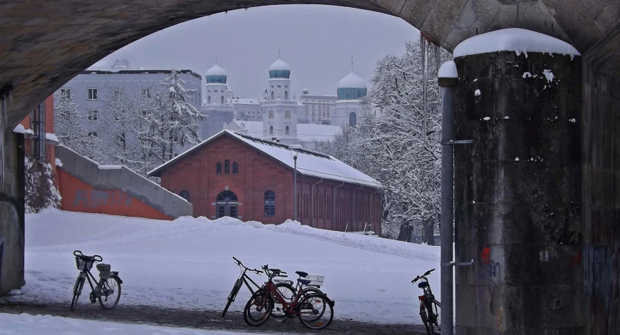 bikes in the snow at a snowy bridge