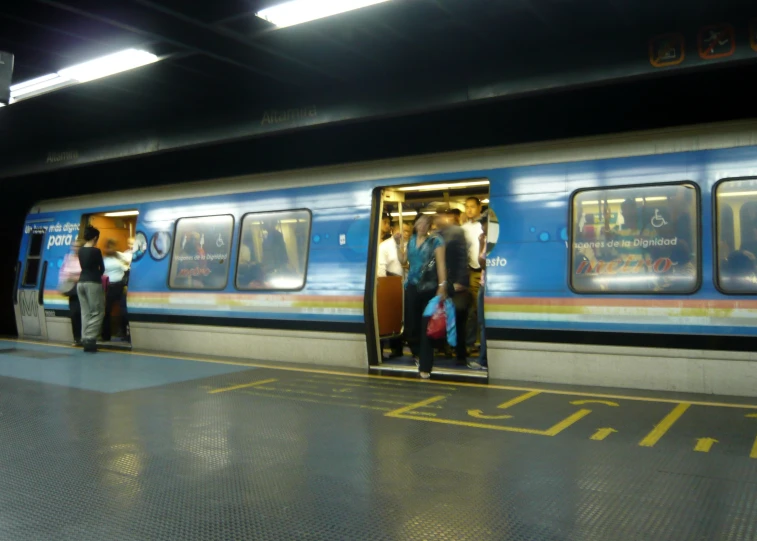 group of people getting on a commuter train