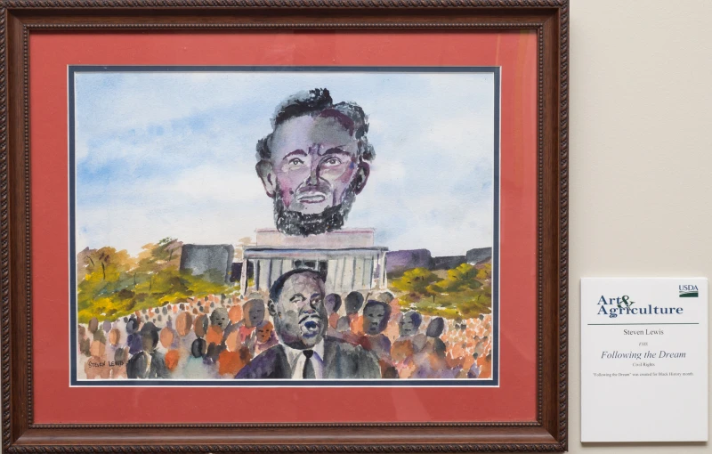 a framed drawing of martin luther king and a crowd of people